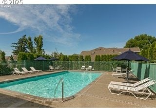 pool with fence and a patio area