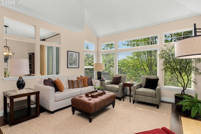 living room with a fireplace with flush hearth, high vaulted ceiling, plenty of natural light, and baseboards