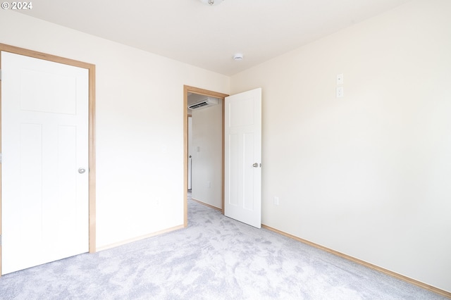 unfurnished bedroom featuring light colored carpet