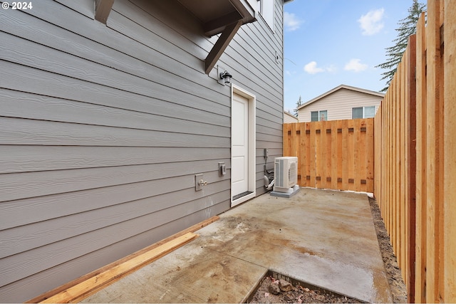 view of side of property with ac unit and a patio area