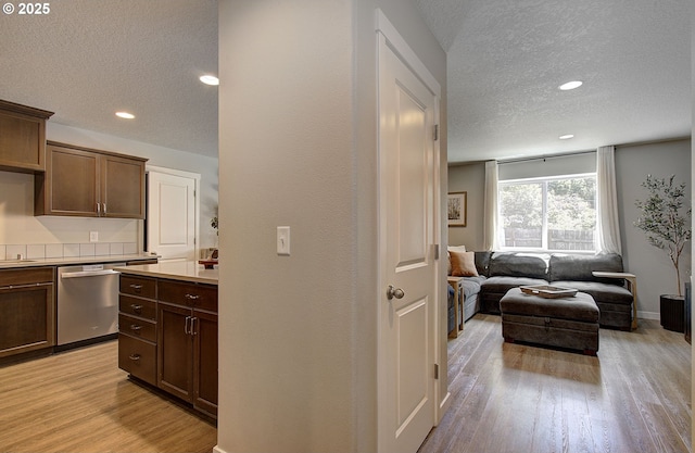 7407 NE 136th Ave, Vancouver, WA 98682 - kitchen with dishwasher, a textured ceiling, light wood-type flooring, light countertops, and open floor plan
