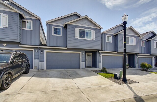 7407 NE 136th Ave, Vancouver, WA 98682 - multi unit property with a garage, concrete driveway, and board and batten siding
