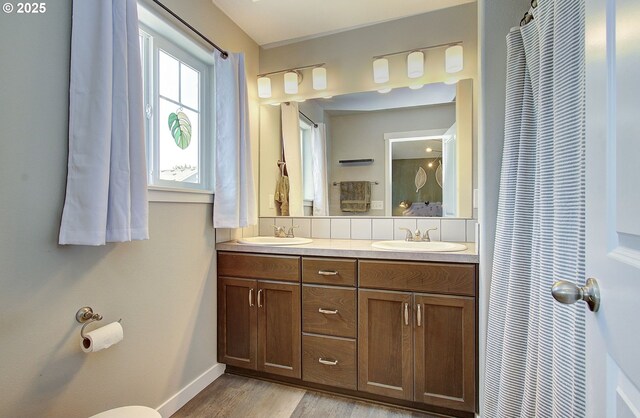 7407 NE 136th Ave, Vancouver, WA 98682 - bathroom featuring double vanity and wood finished floors