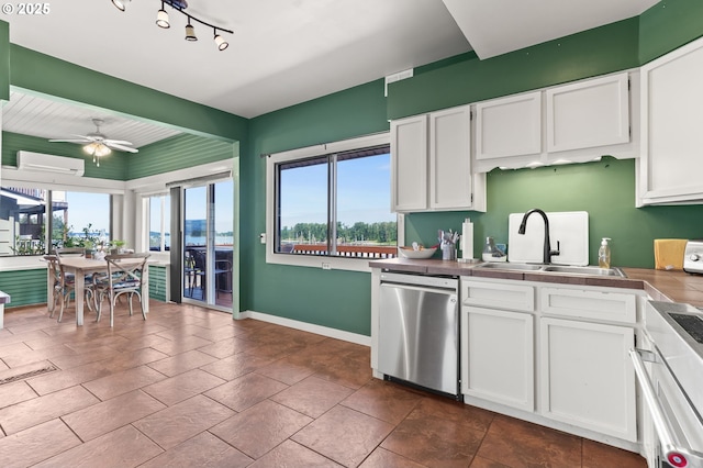 160 S 1st St, Saint Helens, OR 97051 - kitchen with stainless steel dishwasher, a sink, range, white cabinetry, and tile counters