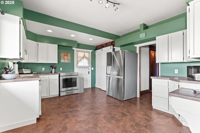 160 S 1st St, Saint Helens, OR 97051 - kitchen with stainless steel appliances, white cabinets, recessed lighting, and light countertops