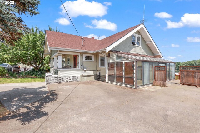 160 S 1st St, Saint Helens, OR 97051 - back of property with a sunroom, a shingled roof, a patio area, and a chimney