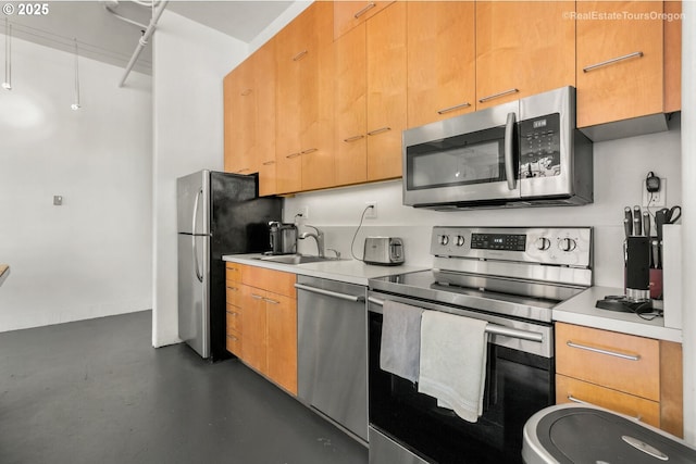 1314 NW Irving St Unit 510, Portland, OR 97209 - kitchen with stainless steel appliances, light countertops, finished concrete flooring, and a sink