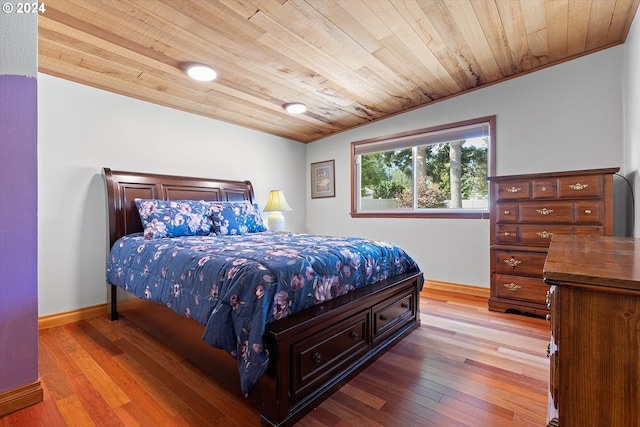 bedroom featuring wood-type flooring, wooden ceiling, and baseboards