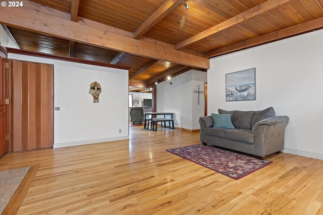 living room featuring wooden ceiling, beamed ceiling, baseboards, and wood finished floors