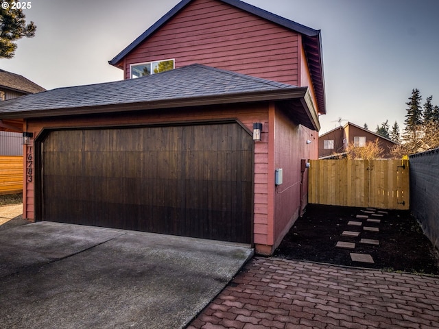 view of garage at dusk