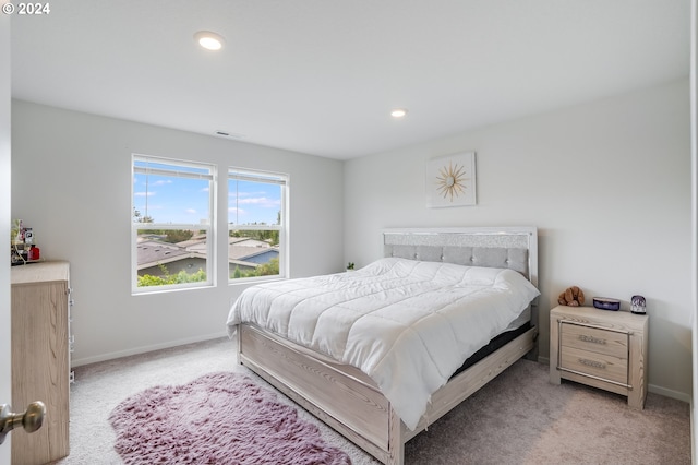 bedroom featuring visible vents, baseboards, recessed lighting, and light colored carpet