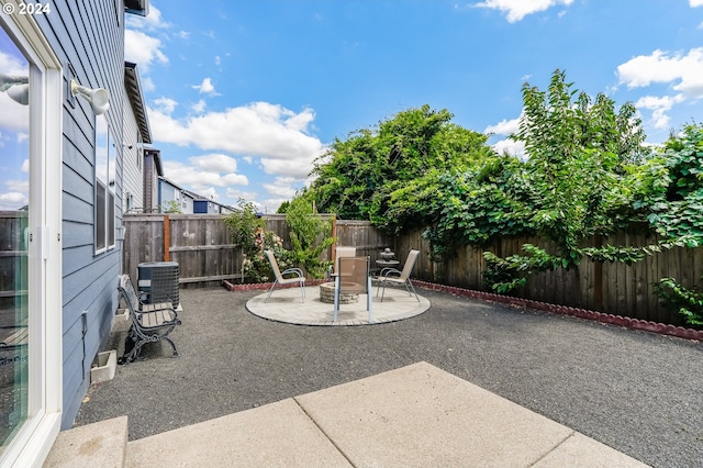view of patio with a fenced backyard and central AC unit