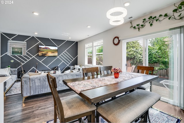 dining area featuring a chandelier, recessed lighting, an accent wall, visible vents, and wood finished floors
