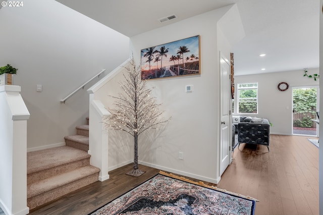 stairs with visible vents, baseboards, recessed lighting, and hardwood / wood-style flooring