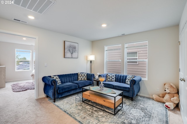 living area featuring carpet flooring, baseboards, and visible vents