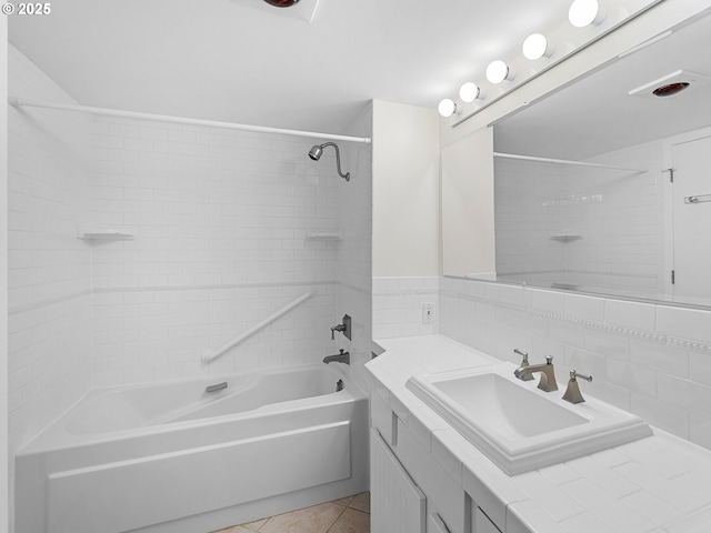 bathroom featuring tiled shower / bath combo, vanity, tile patterned flooring, and backsplash