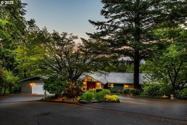 view of front of property featuring aphalt driveway and a detached garage