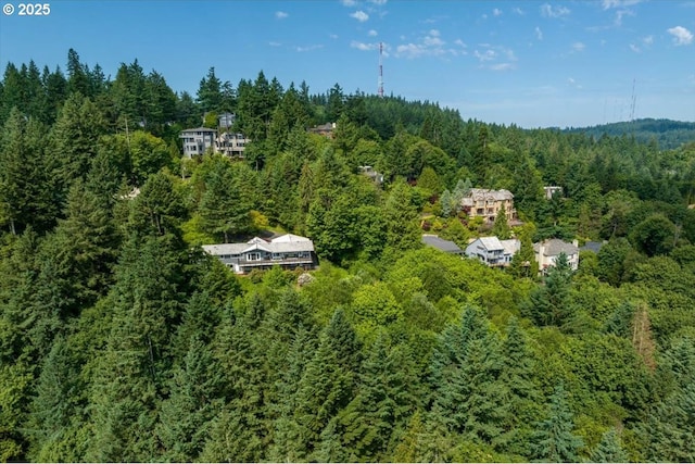 birds eye view of property featuring a wooded view