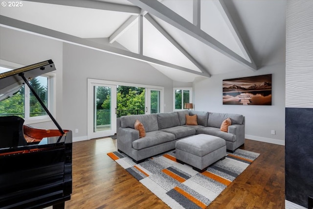 living area featuring baseboards, vaulted ceiling with beams, and wood finished floors