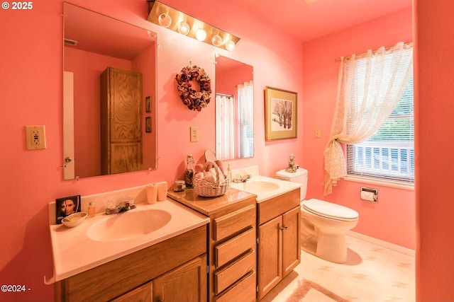 2165 NE E Devils Lake Rd, Otis, OR 97368 - full bathroom with double vanity, toilet, and tile patterned floors