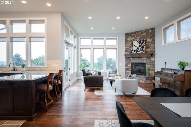 3232 NW Spencer St, Portland, OR 97229 - living room featuring dark wood-type flooring, recessed lighting, and a stone fireplace