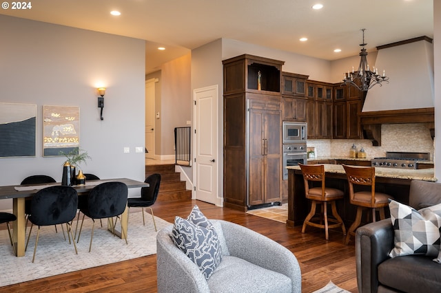 3232 NW Spencer St, Portland, OR 97229 - living room featuring a chandelier, recessed lighting, dark wood finished floors, and stairway