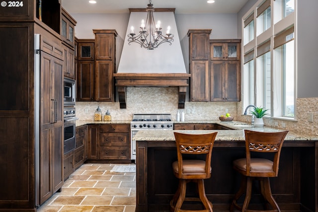 3232 NW Spencer St, Portland, OR 97229 - kitchen featuring stainless steel appliances, plenty of natural light, decorative backsplash, a peninsula, and recessed lighting
