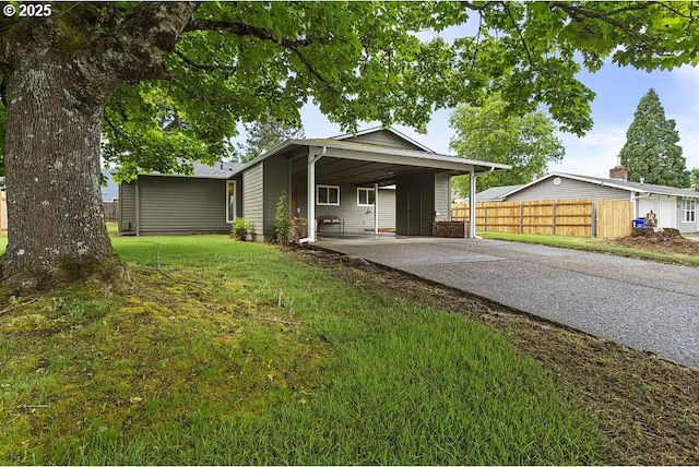 view of front of home with concrete driveway and an attached carport
