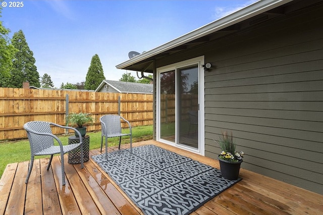wooden terrace featuring fence