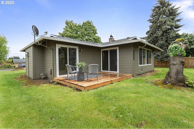 rear view of house featuring a deck and a chimney