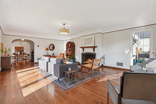 living room featuring hardwood / wood-style floors and a brick fireplace