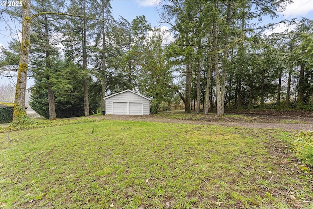 view of yard featuring a garage and an outdoor structure