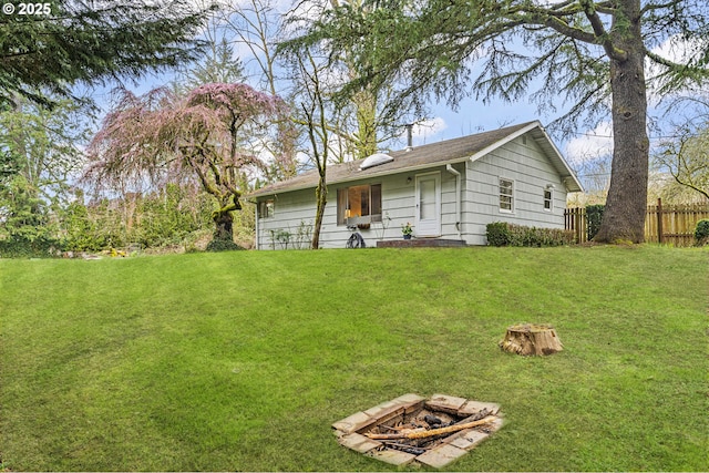 exterior space with a yard, an outdoor fire pit, and fence