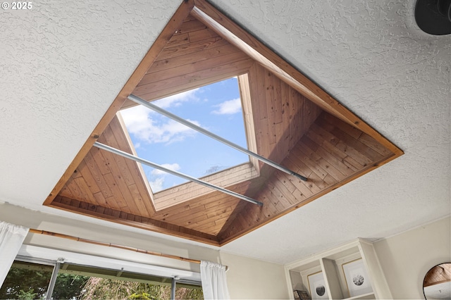 exterior details with stucco siding and a skylight