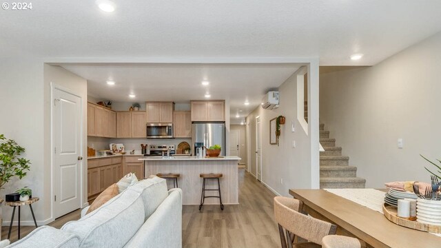 6138 SE 15th St, Gresham, OR 97080 - kitchen featuring stainless steel appliances, light brown cabinets, open floor plan, light countertops, and a center island with sink
