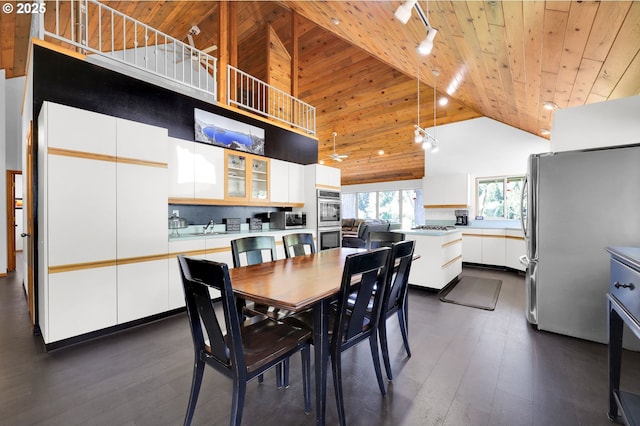 dining room with wooden ceiling, high vaulted ceiling, dark wood-type flooring, and rail lighting