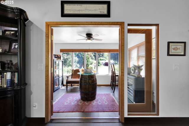 dining space featuring a ceiling fan and wood finished floors