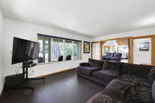 living room featuring hardwood / wood-style flooring and baseboards