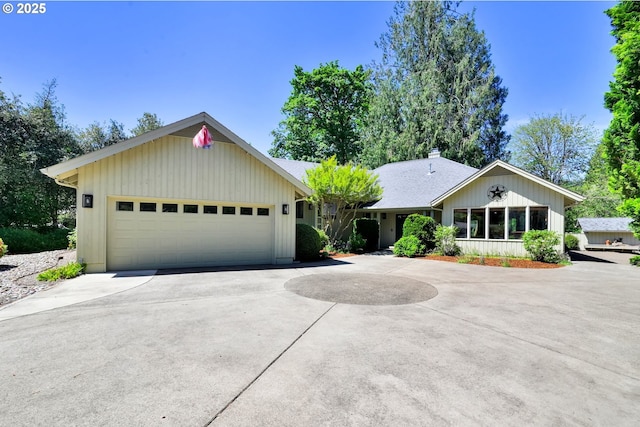 single story home with driveway, an attached garage, and a chimney
