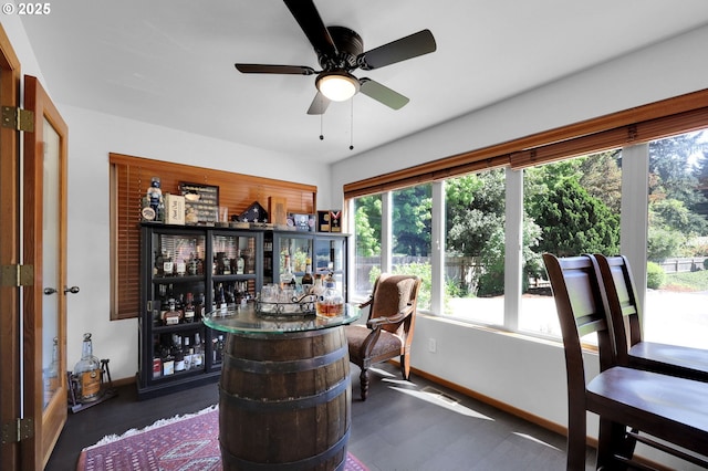 indoor dry bar featuring baseboards, a ceiling fan, and dark wood-style flooring