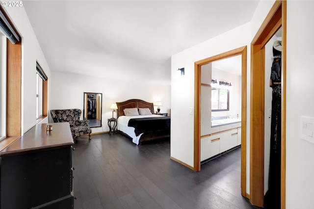 bedroom featuring dark wood-style floors and a sink