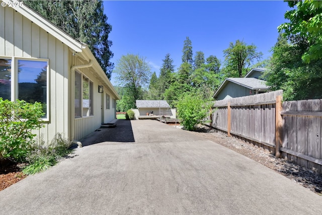 view of home's exterior featuring fence and driveway