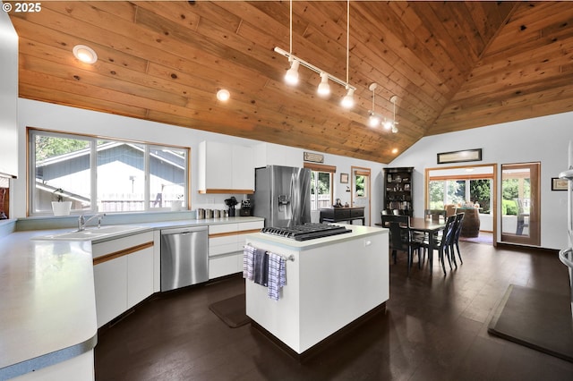 kitchen featuring stainless steel appliances, rail lighting, wood ceiling, a sink, and white cabinets