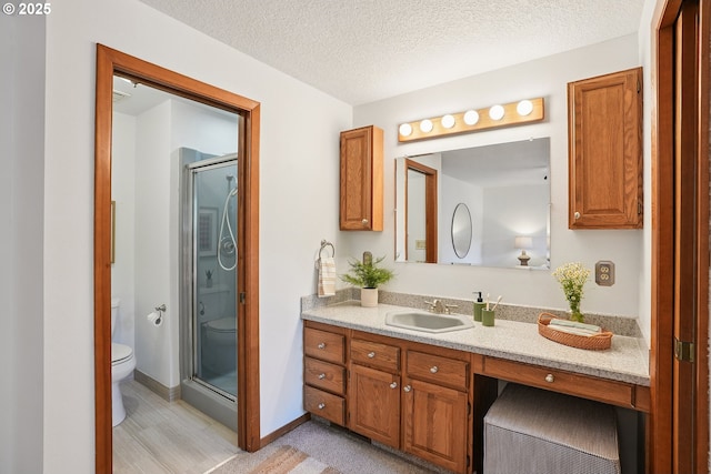 2027 SE Lexington St, Portland, OR 97202 - full bathroom with vanity, a stall shower, wood finished floors, and a textured ceiling