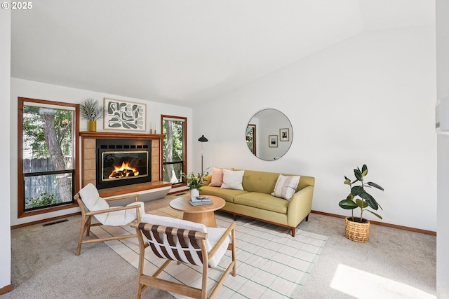 2027 SE Lexington St, Portland, OR 97202 - living area featuring vaulted ceiling, healthy amount of natural light, a tiled fireplace, and carpet floors