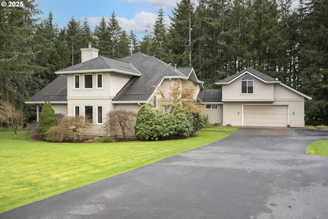 view of front of property with a front lawn, aphalt driveway, roof with shingles, and a chimney