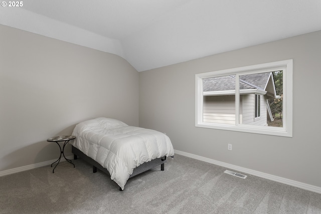 bedroom with baseboards, carpet, lofted ceiling, and visible vents