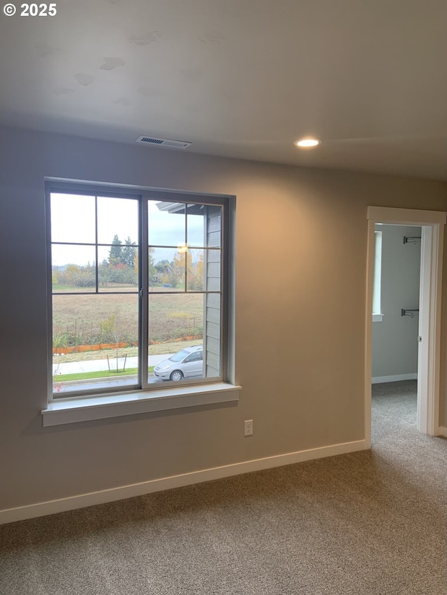 carpeted empty room featuring recessed lighting, baseboards, and plenty of natural light
