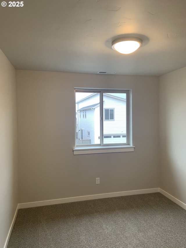 unfurnished room featuring baseboards, carpet, and visible vents