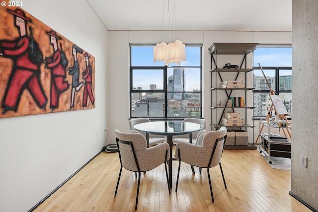 333 NW 9th Ave Unit 1205, Portland, OR 97209 - dining room featuring hardwood / wood-style floors and a city view